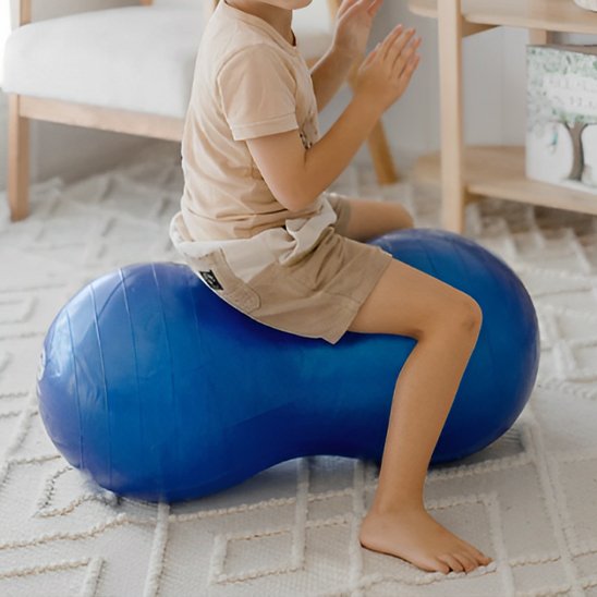 ballon de yoga cacahuète, un garçon joue sur un ballon