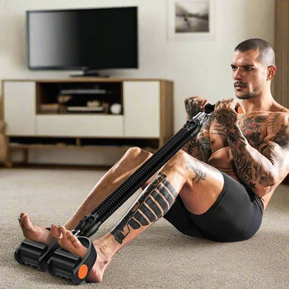 homme assis au sol les pieds à l'intérieur de l'elastique musculation et tire el poignet avec les mains 